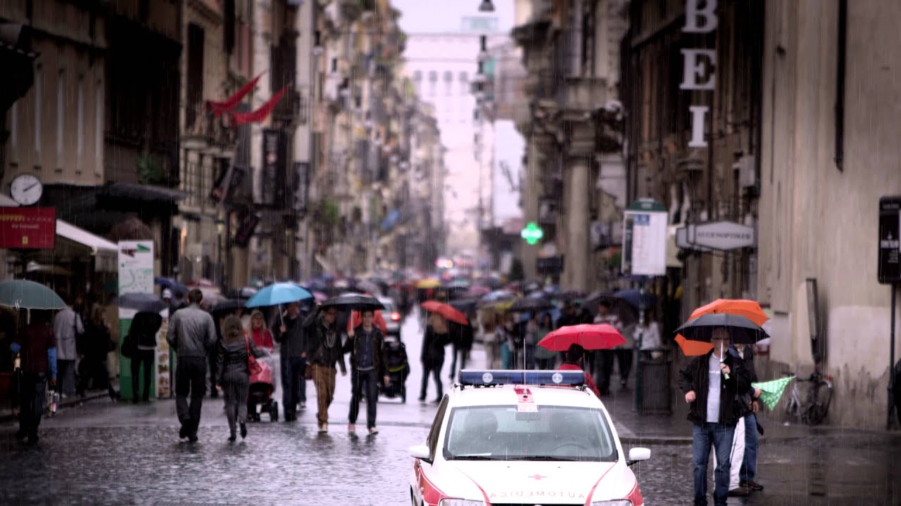 a group of people walking down a busy city street